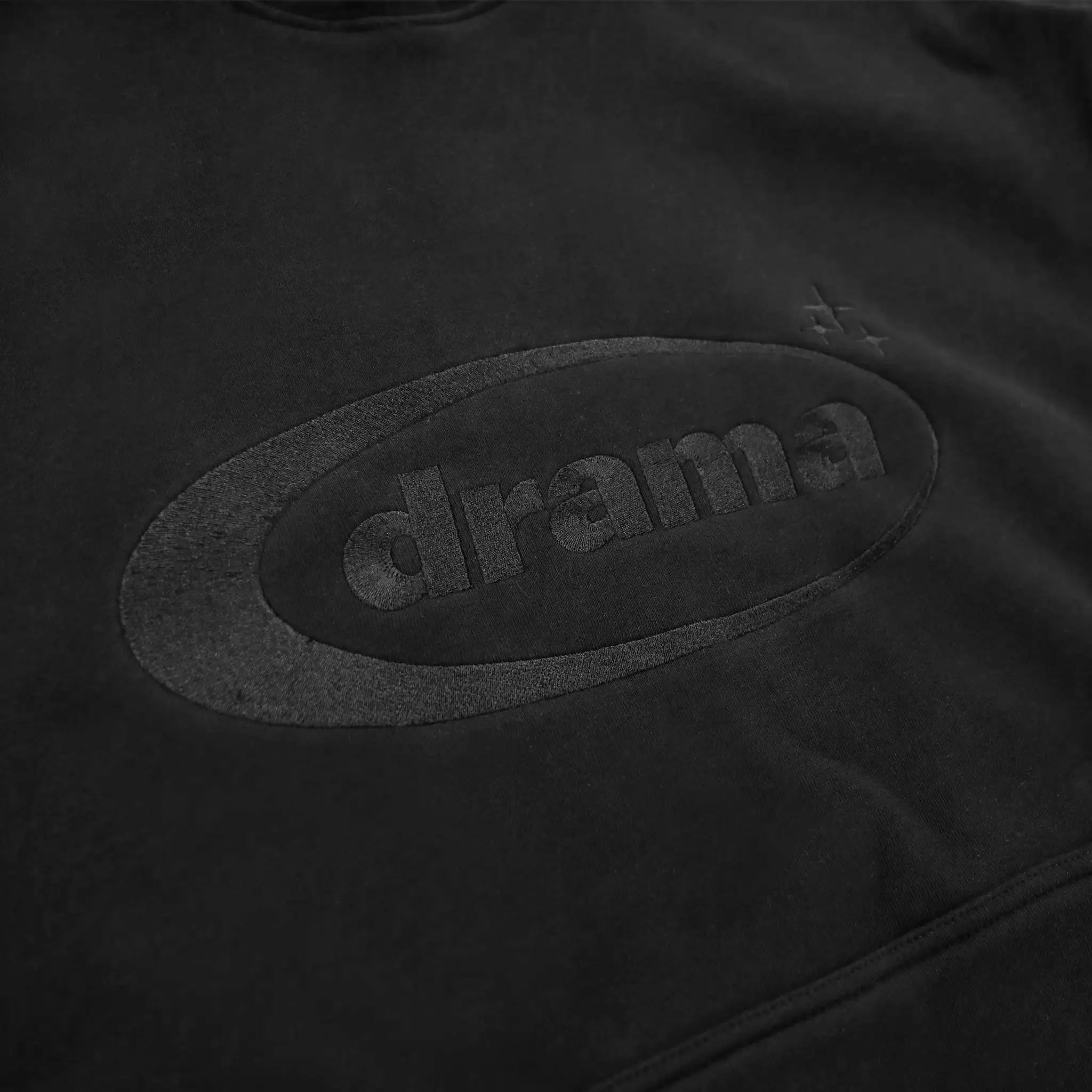 Logo view of Drama Call Oval Black Hoodie